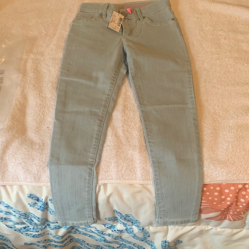 Place child’s light blue skinny leg jeans